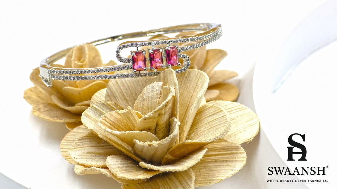 Silver bracelet with three pink baguette stones and dual pavé crystal swirl lines – Swaansh