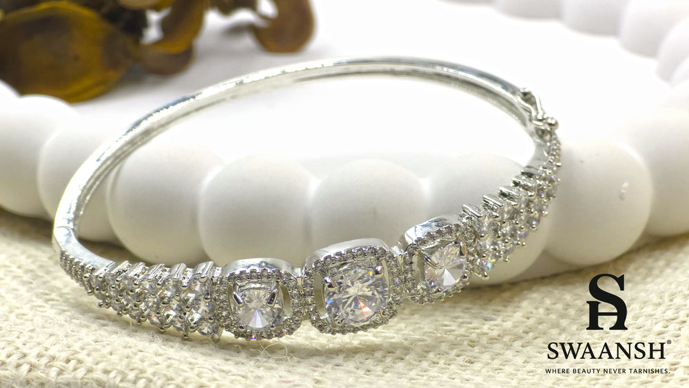 Anti-tarnish silver bracelet with three cushion-cut CZ stones in halo setting, tapering design – Swaansh