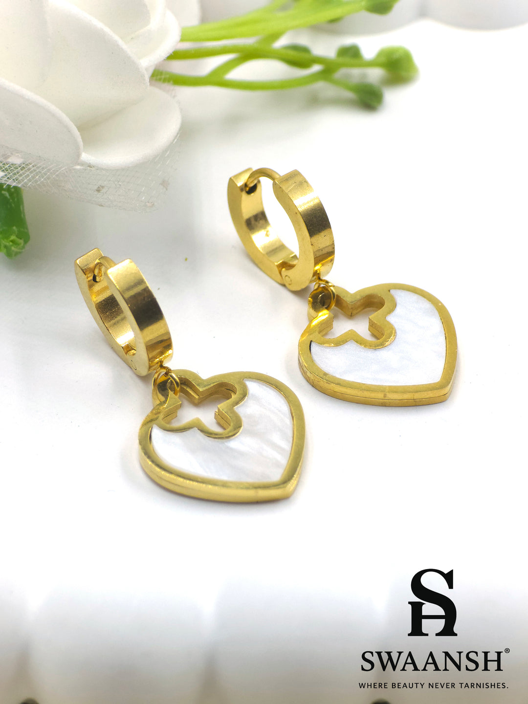 Gold hoop earrings with heart-shaped white pearl inlay drop charms – floral cutout design by Swaansh