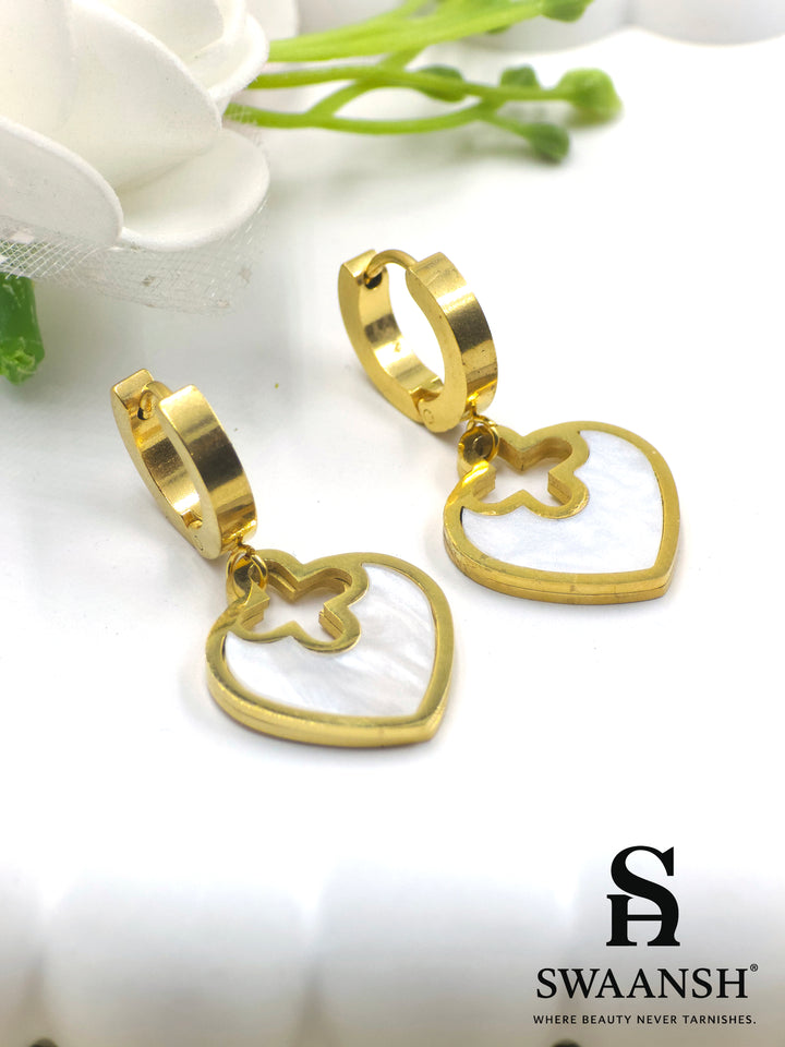 Gold hoop earrings with heart-shaped white pearl inlay drop charms – floral cutout design by Swaansh