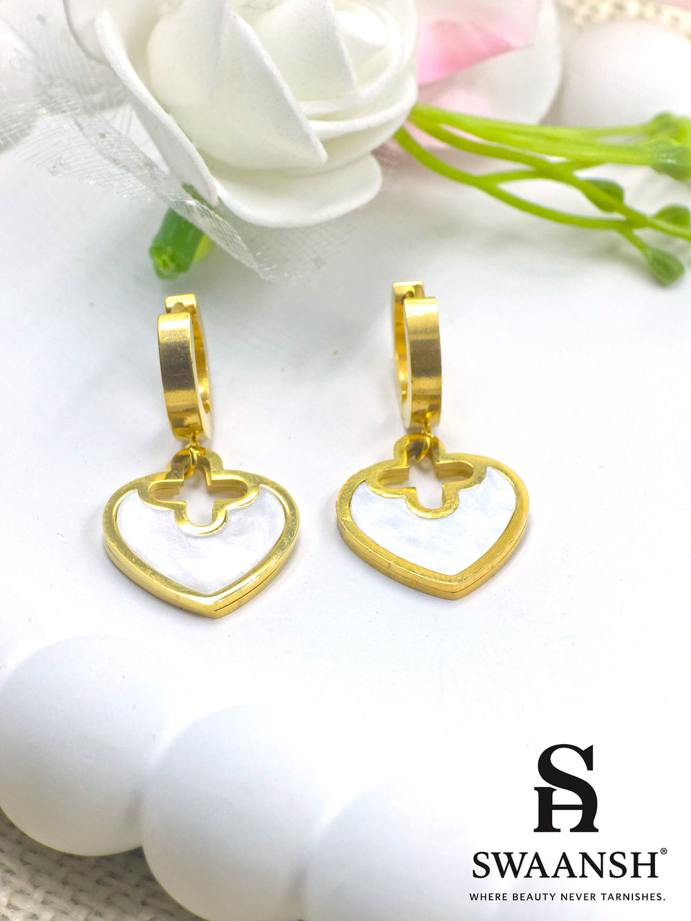Gold hoop earrings with heart-shaped white pearl inlay drop charms – floral cutout design by Swaansh
