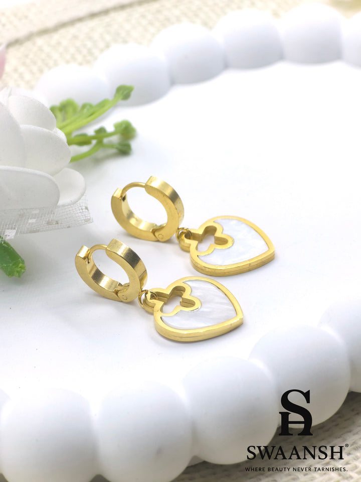 Gold hoop earrings with heart-shaped white pearl inlay drop charms – floral cutout design by Swaansh