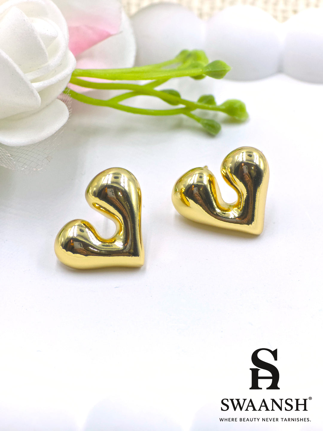 Gold melted heart-shaped stud earrings on white background – Swaansh 