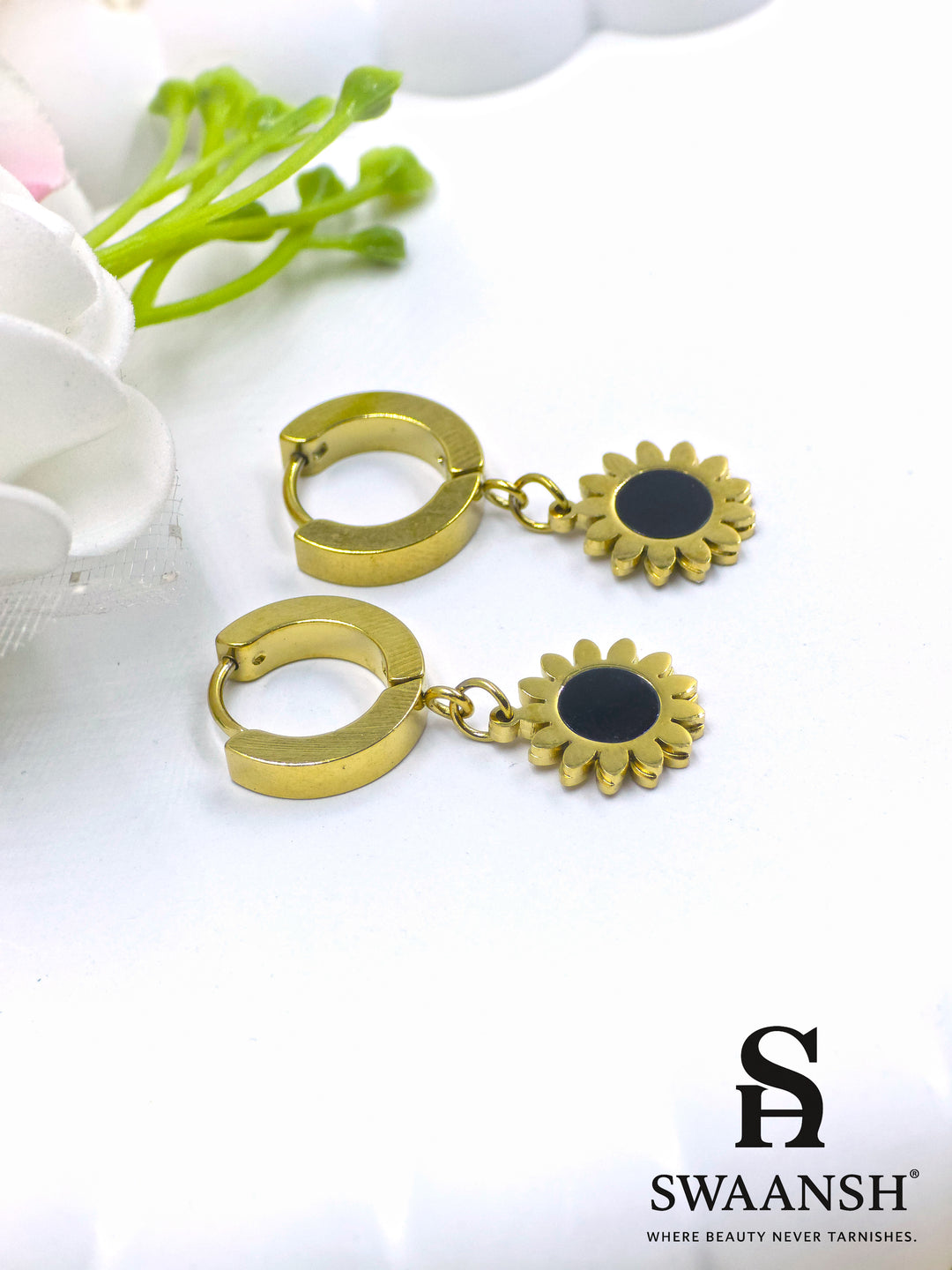 Black stone round stud gold earring – front view on white backdrop.