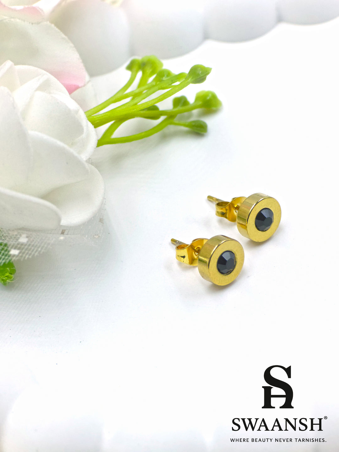 Black stone round stud gold earring – front view on white backdrop.