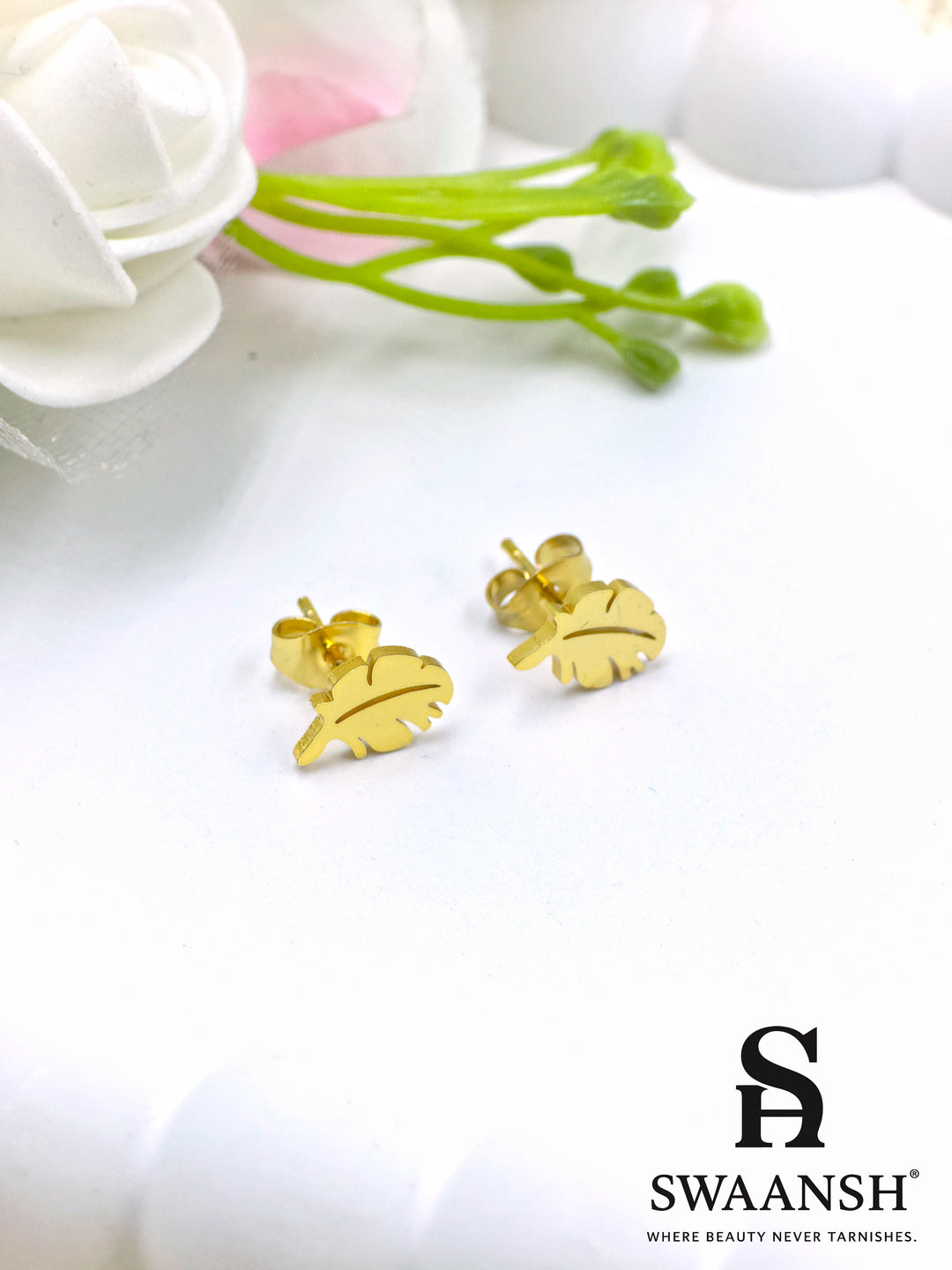 Black stone round stud gold earring – front view on white backdrop.