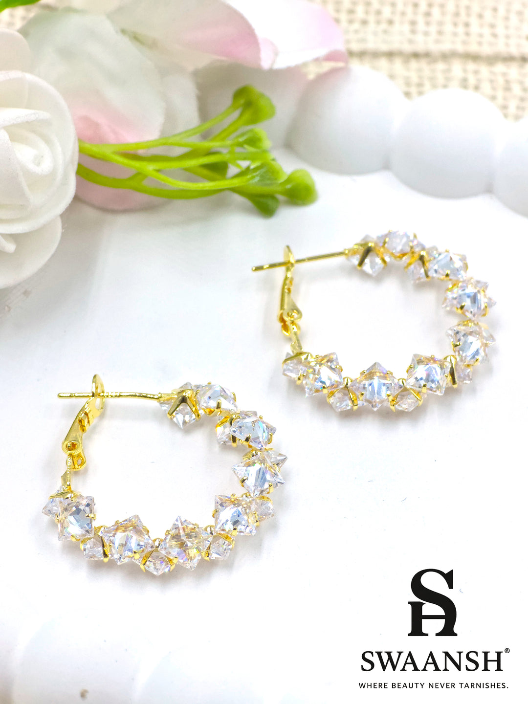 Crystal gold hoop earrings with prism-cut stones on white background – Swaansh 