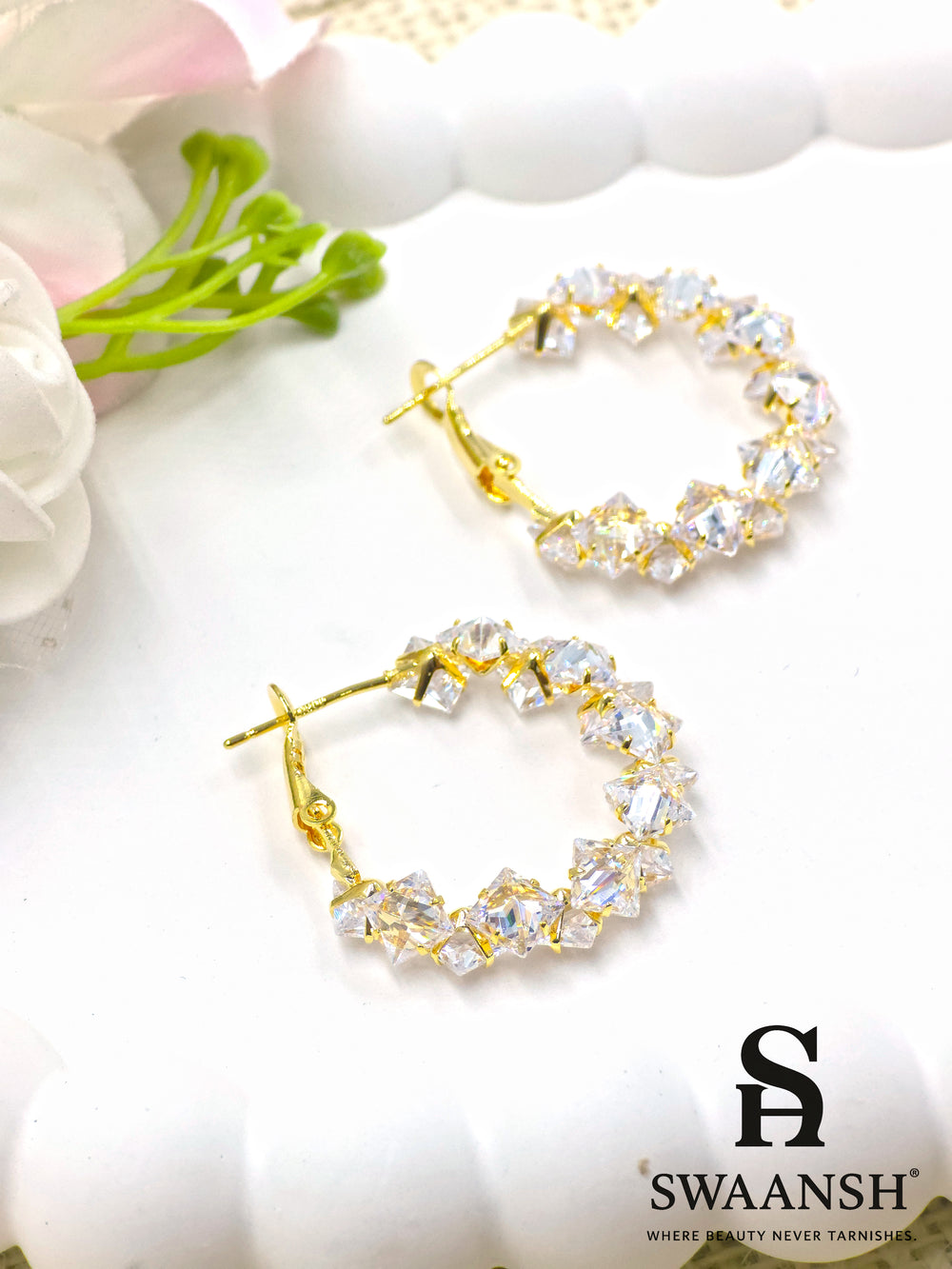 Crystal gold hoop earrings with prism-cut stones on white background – Swaansh 