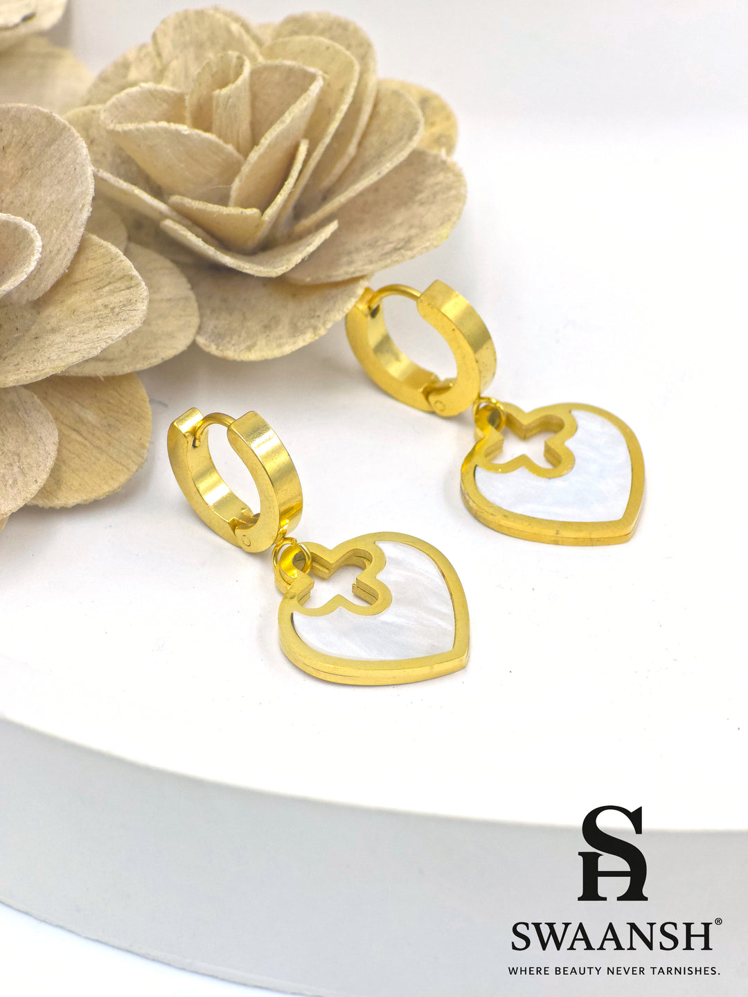 Gold hoop earrings with heart-shaped white pearl inlay drop charms – floral cutout design by Swaansh