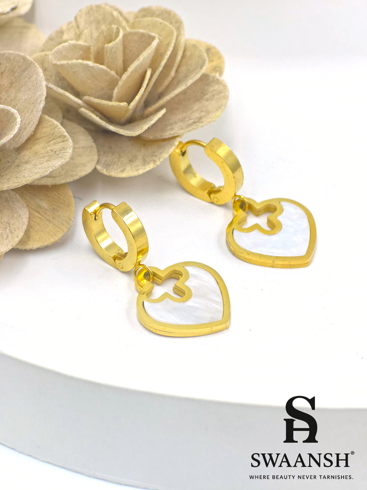 Gold hoop earrings with heart-shaped white pearl inlay drop charms – floral cutout design by Swaansh