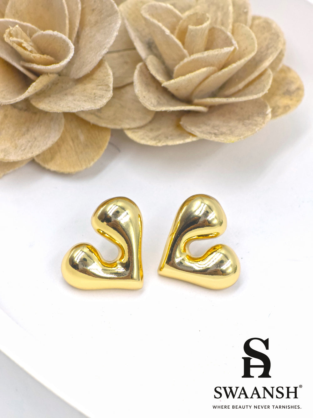 Gold melted heart-shaped stud earrings on white background – Swaansh 