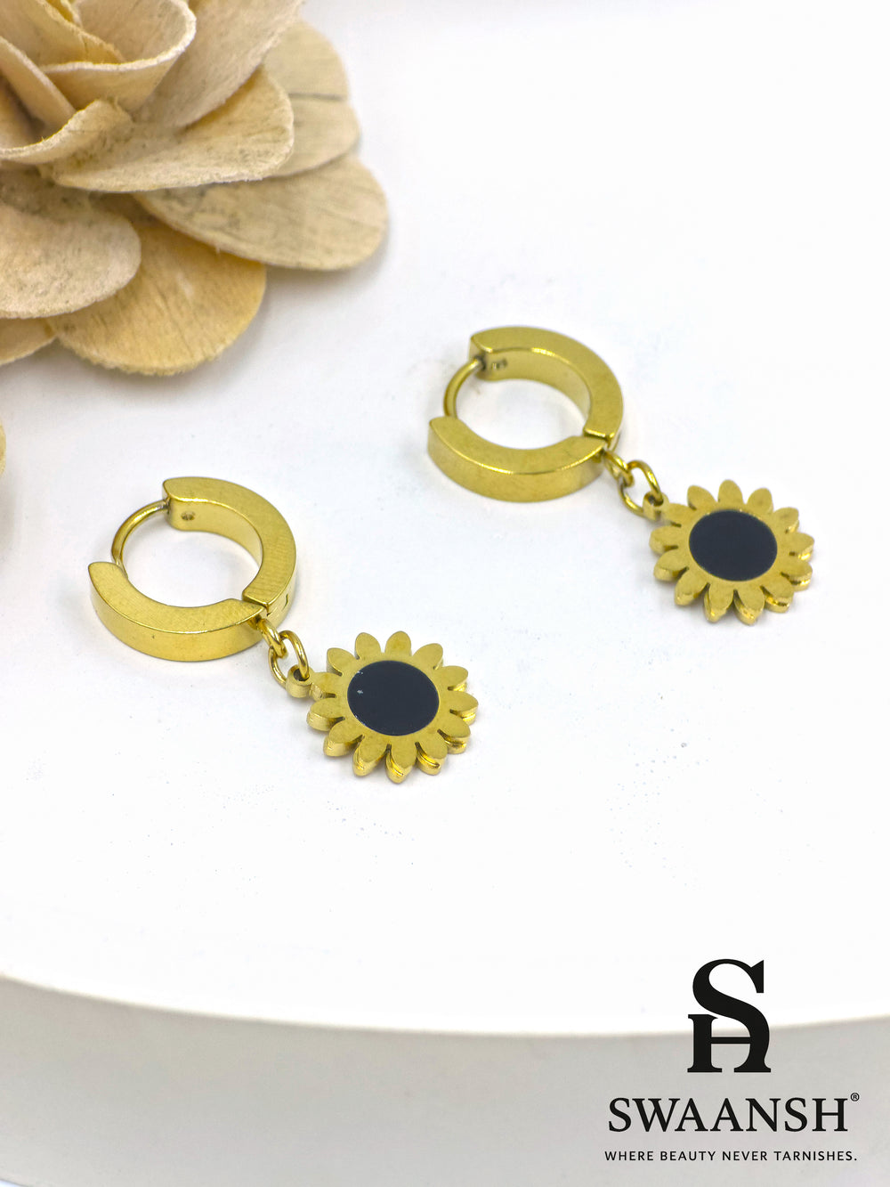 Black stone round stud gold earring – front view on white backdrop.