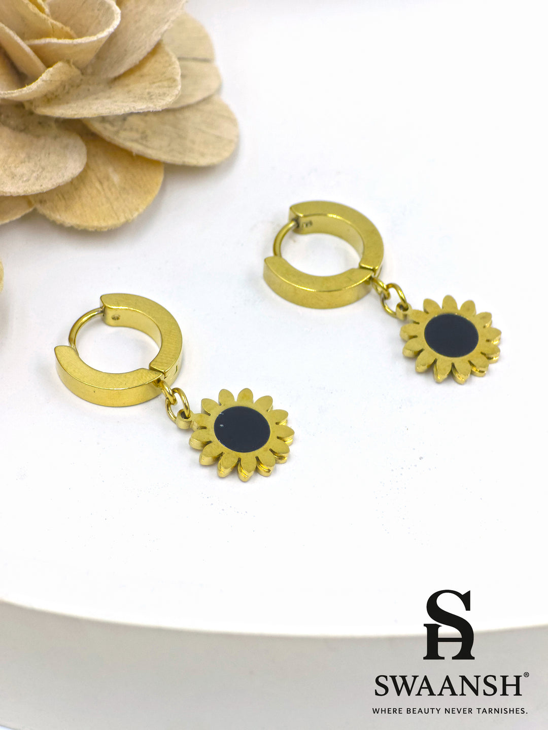 Black stone round stud gold earring – front view on white backdrop.