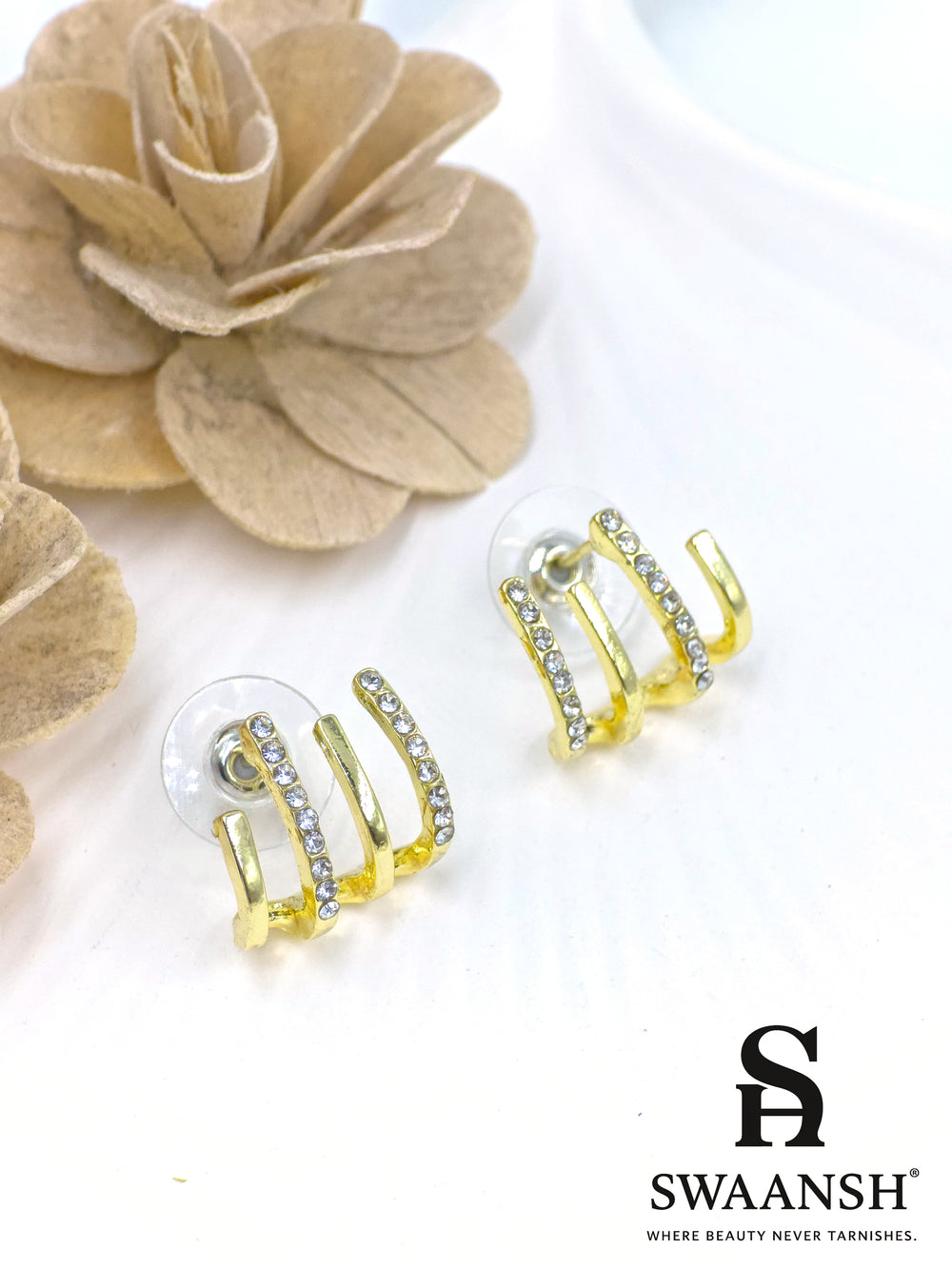 Triple arc illusion stud earrings with gold finish and white crystals – Swaansh statement piece