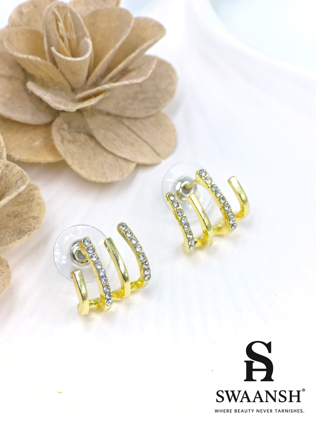 Triple arc illusion stud earrings with gold finish and white crystals – Swaansh statement piece
