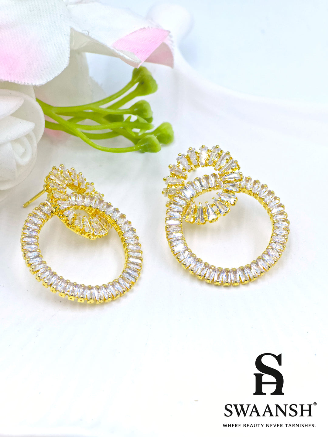 Gold double-loop earrings with baguette crystals in a luxe sculptural design – Swaansh