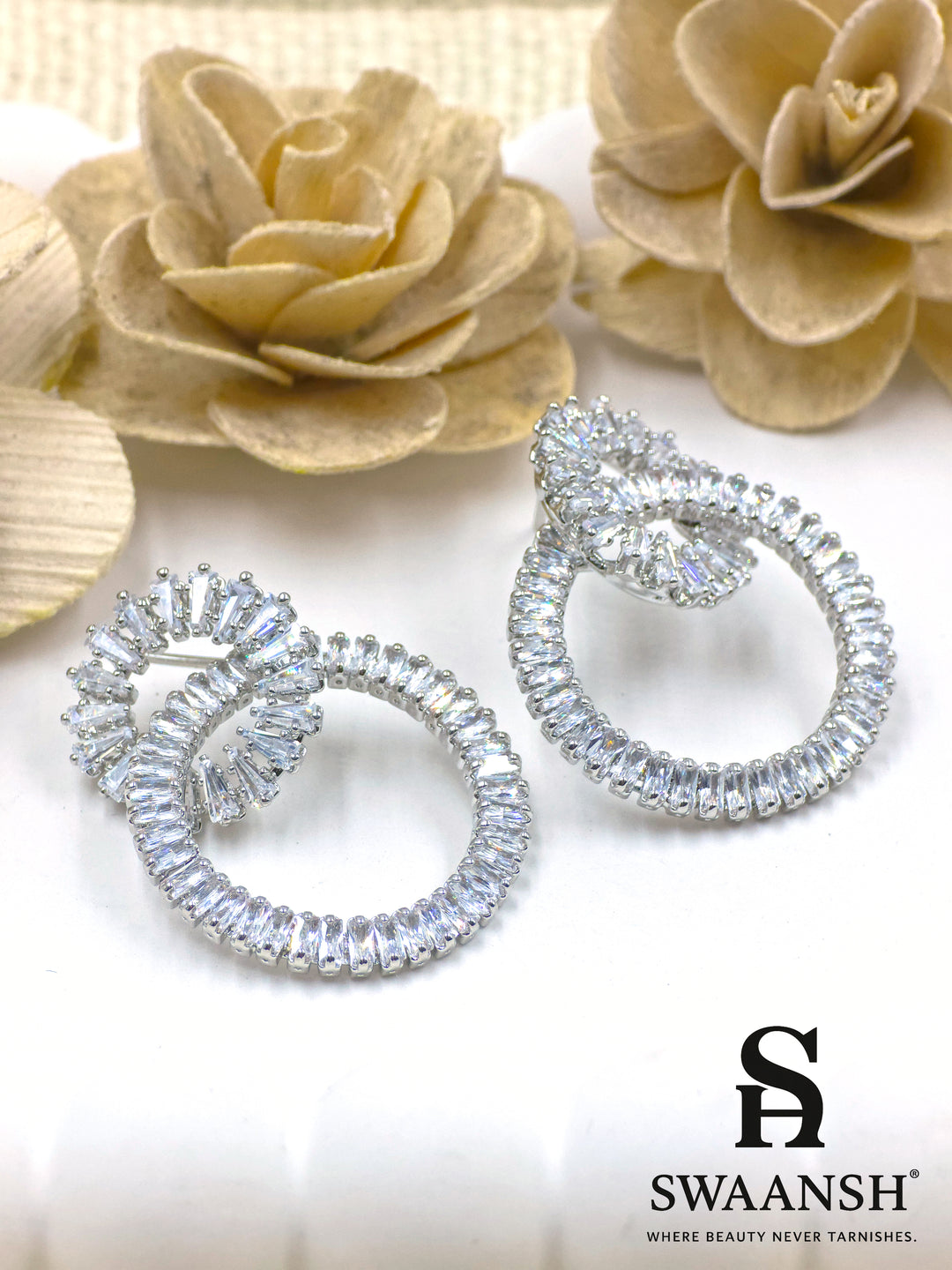 Silver dual-loop earrings with baguette-cut crystal detailing in luxe sculptural form – Swaansh