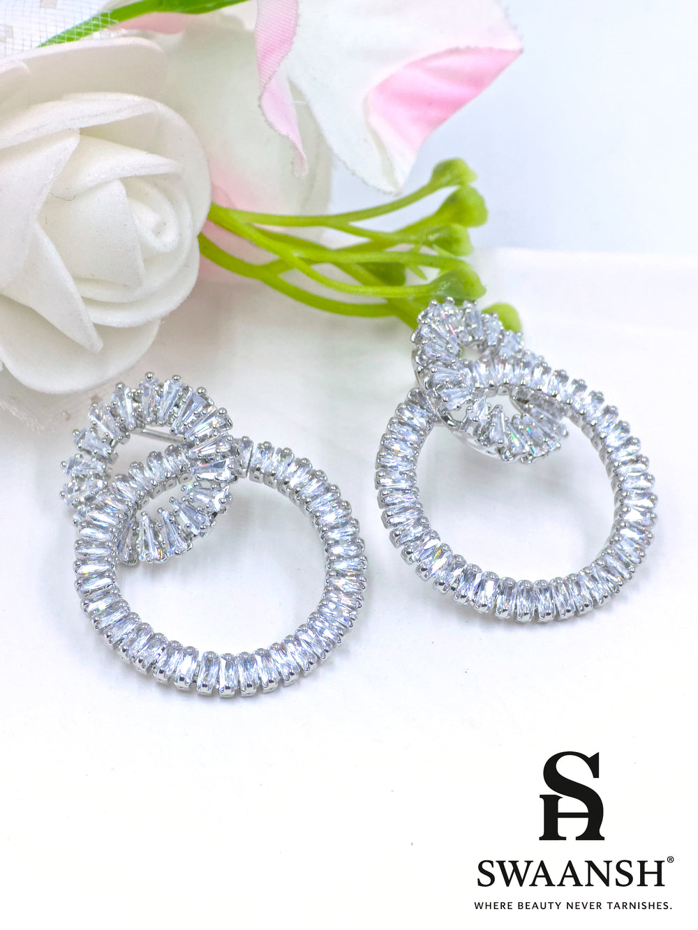 Silver dual-loop earrings with baguette-cut crystal detailing in luxe sculptural form – Swaansh
