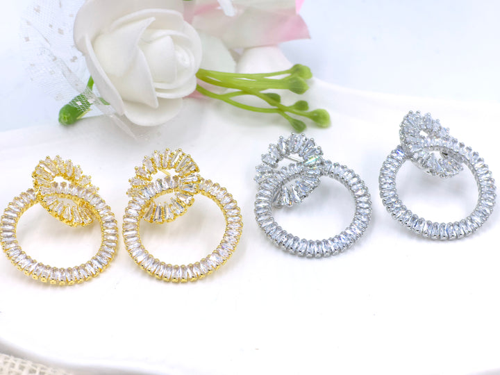 Silver dual-loop earrings with baguette-cut crystal detailing in luxe sculptural form – Swaansh