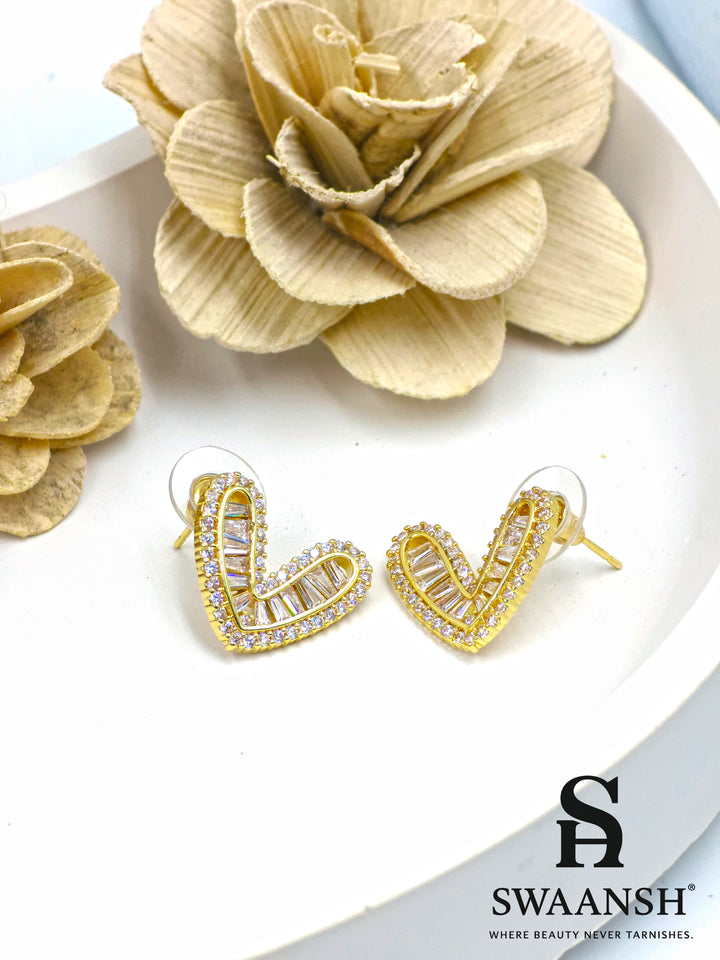 Gold heart-shaped stud earrings with baguette and micro crystal detailing – Swaansh