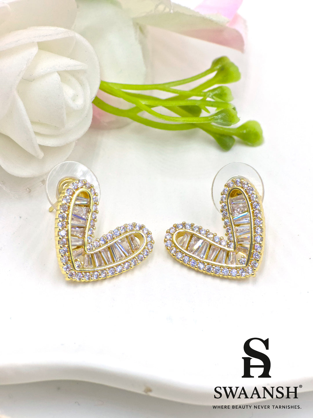 Gold heart-shaped stud earrings with baguette and micro crystal detailing – Swaansh