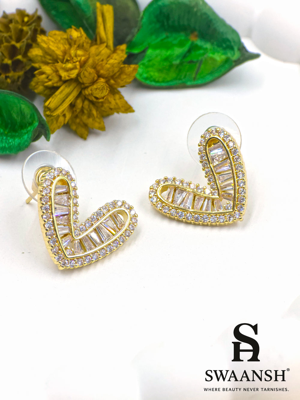 Gold heart-shaped stud earrings with baguette and micro crystal detailing – Swaansh
