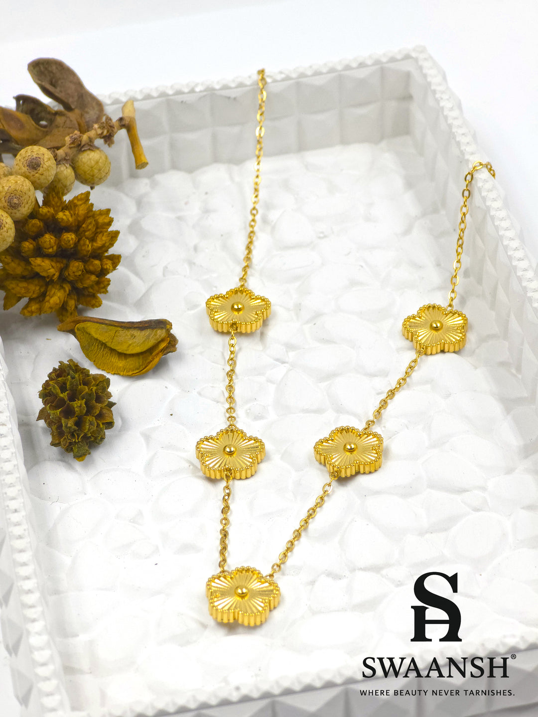Gold chain pendant featuring five embossed floral motifs placed evenly across the necklace – Golden Petal Cascade by Swaansh

