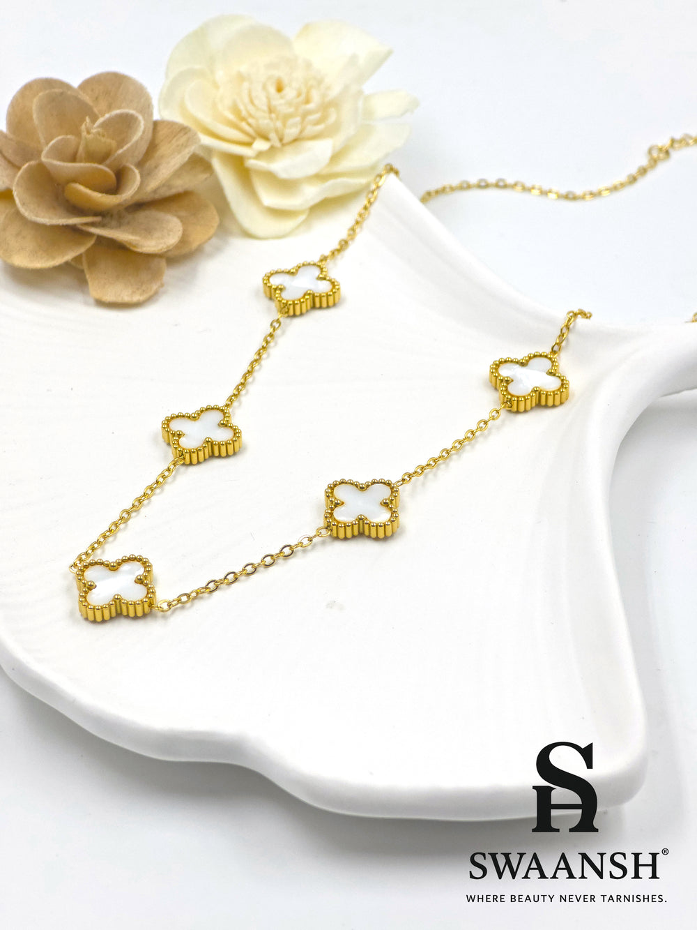 Gold-tone necklace with 5 white clover-shaped motifs placed in a beaded gold border — Pearl Clover Pendant by Swaansh