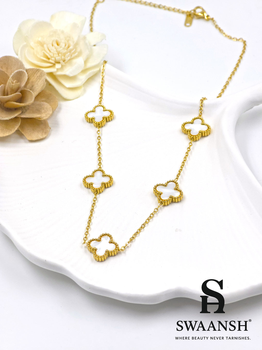 Gold-tone necklace with 5 white clover-shaped motifs placed in a beaded gold border — Pearl Clover Pendant by Swaansh