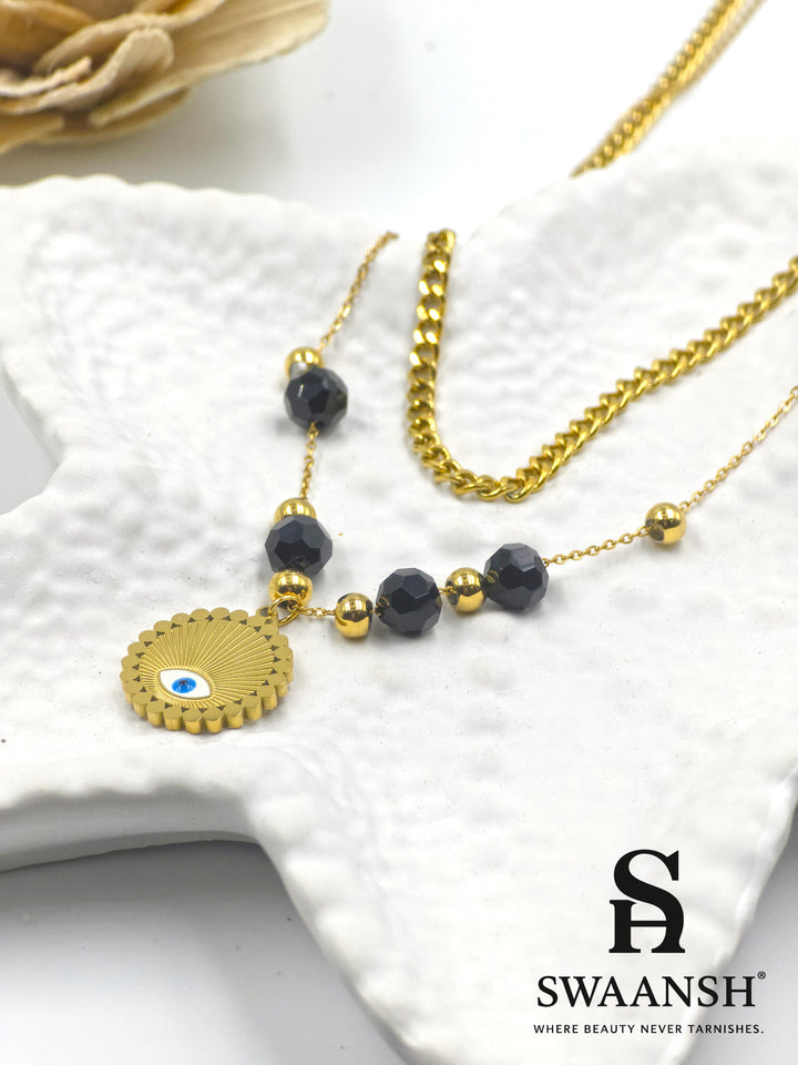 Elysian Shield by Swaansh featuring gold evil eye charm with black and gold bead dual chain