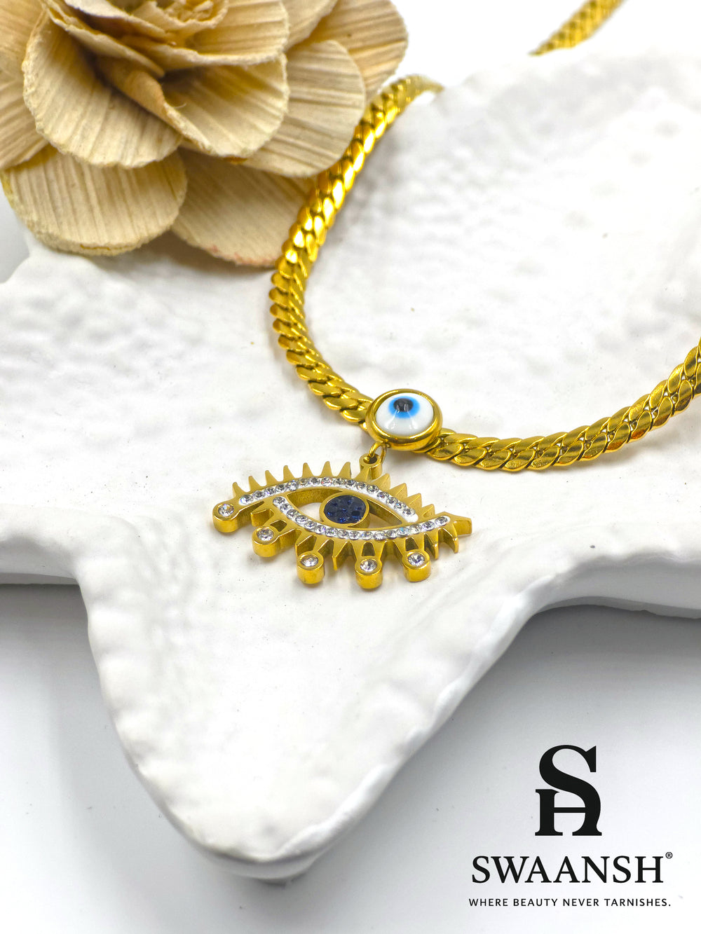 Celestial Eye Pendant by Swaansh featuring dual evil eye charms with gold curb chain and crystal detailing