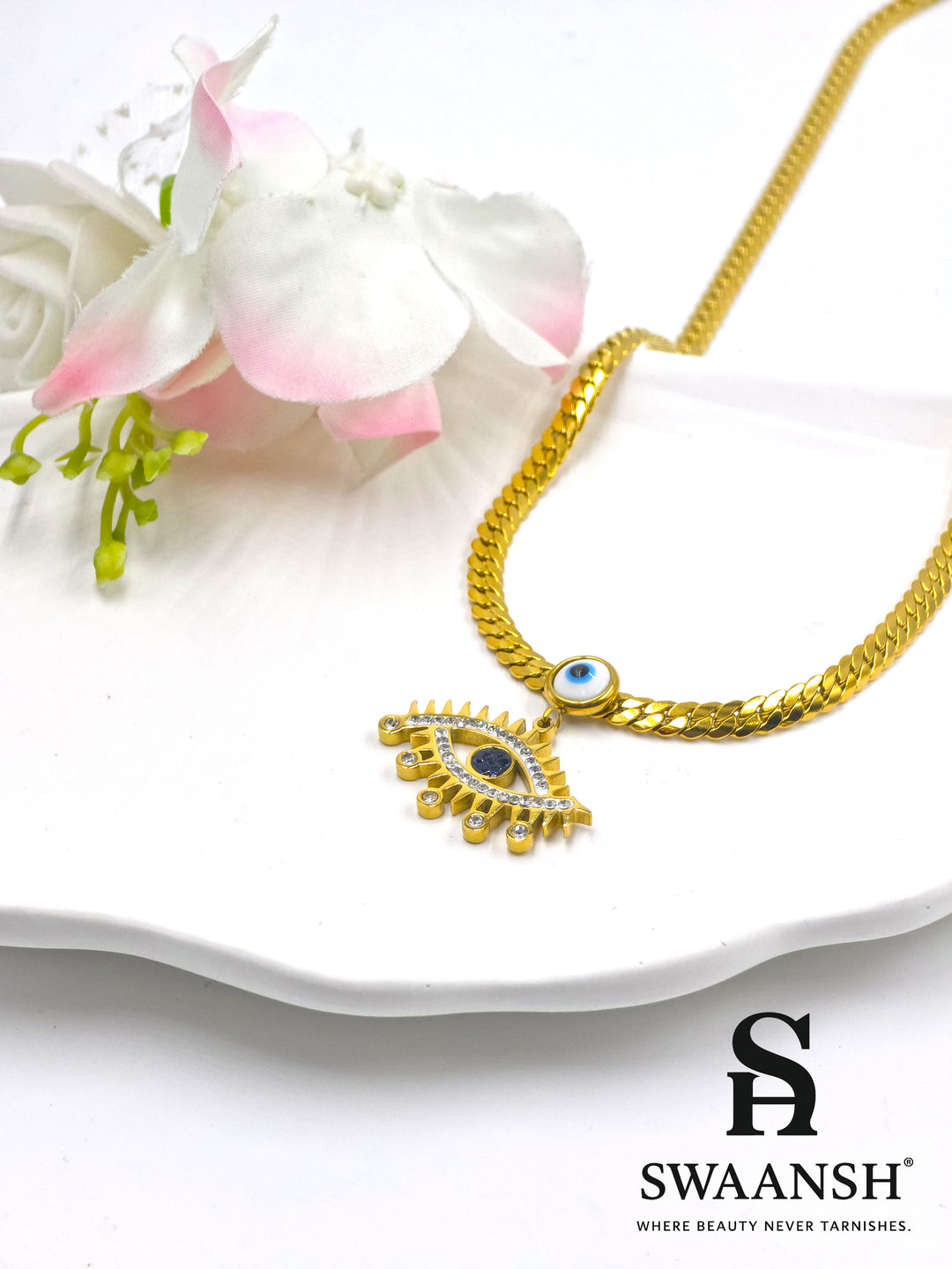 Celestial Eye Pendant by Swaansh featuring dual evil eye charms with gold curb chain and crystal detailing