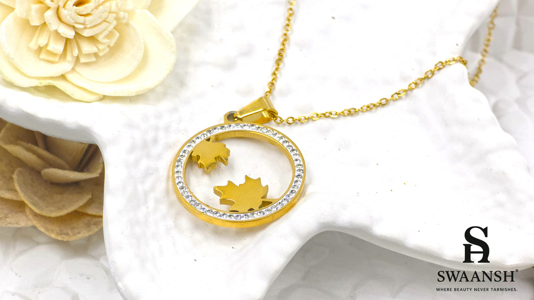 Autumn Radiance Pendant by Swaansh featuring gold maple leaves inside a crystal-lined circular frame