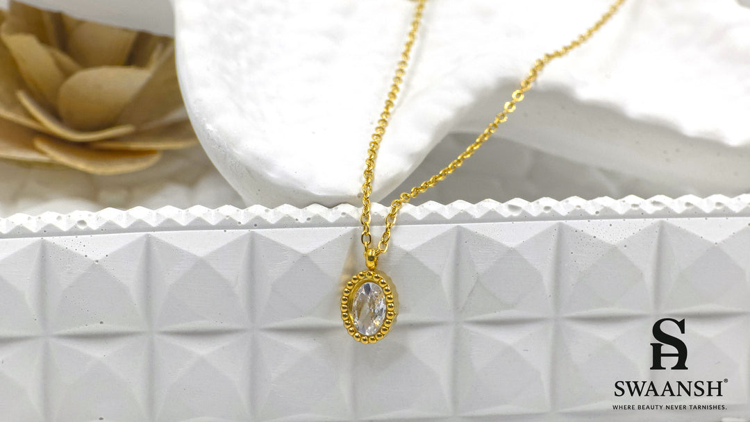 Solace Oval Pendant by Swaansh featuring brilliant oval-cut crystal in a textured gold dotted frame on a fine chain