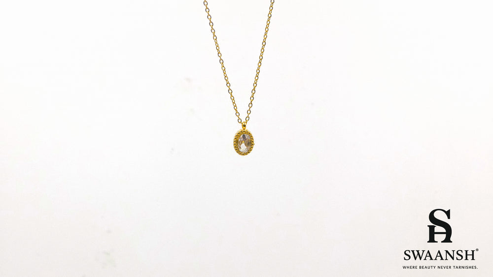 Solace Oval Pendant by Swaansh featuring brilliant oval-cut crystal in a textured gold dotted frame on a fine chain