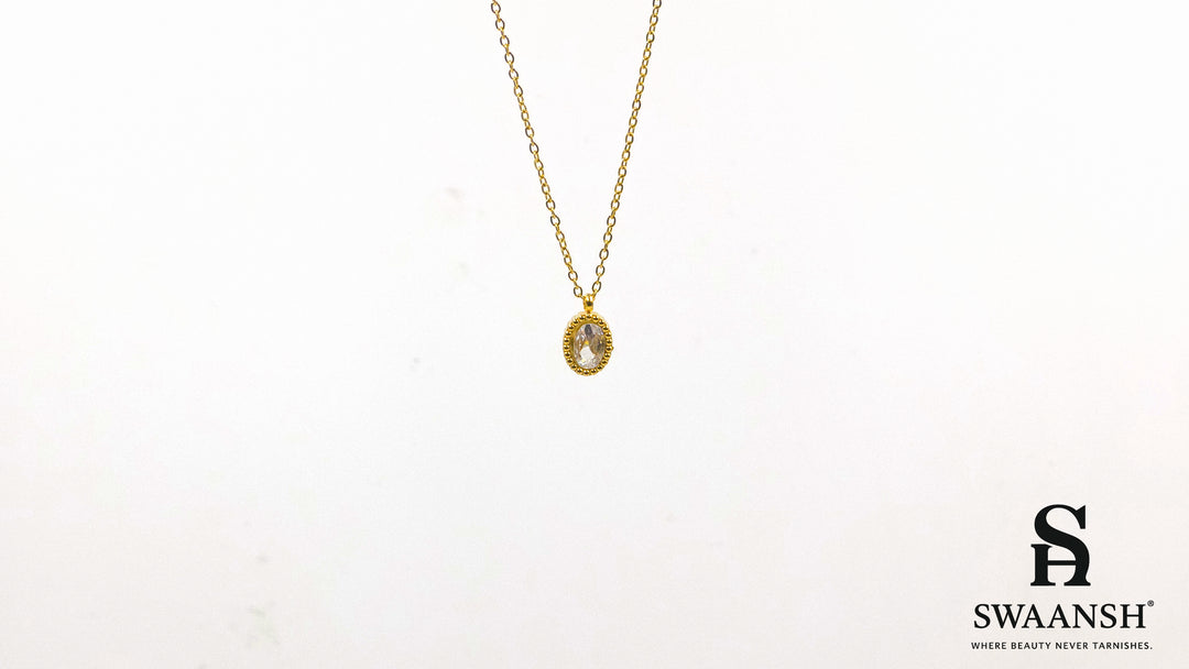 Solace Oval Pendant by Swaansh featuring brilliant oval-cut crystal in a textured gold dotted frame on a fine chain