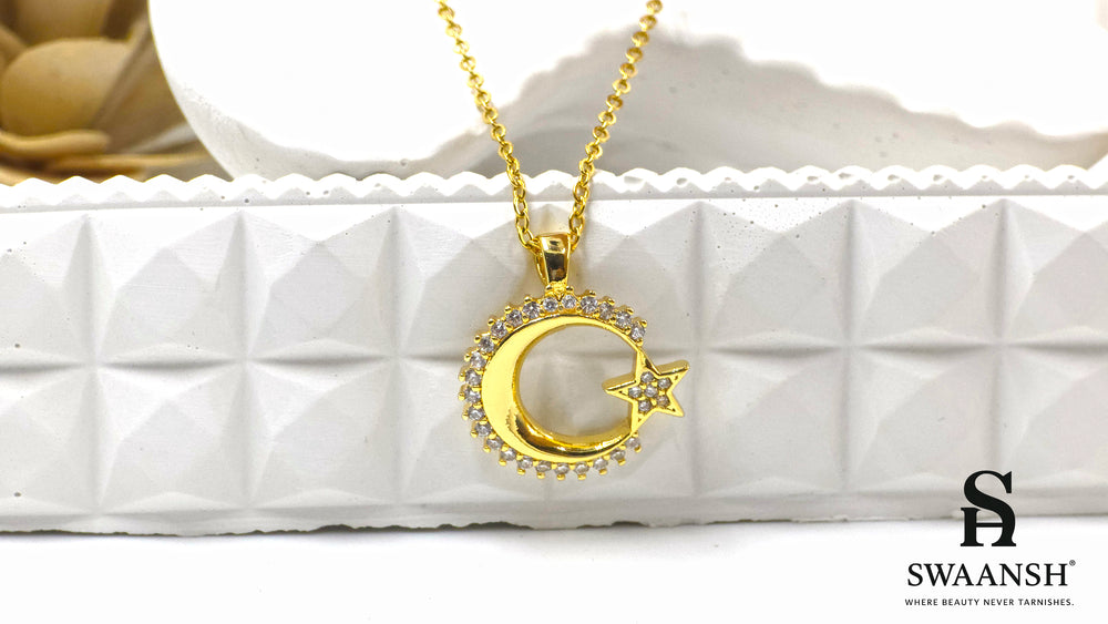 Celestial Glow Pendant by Swaansh featuring gold crescent moon and star with crystal accents on a fine chain