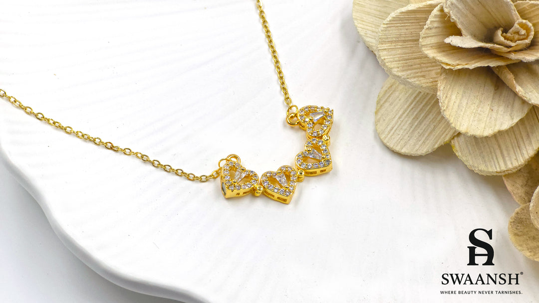 Hearts of Fortune Pendant by Swaansh featuring crystal-studded four-leaf clover and heart cascade designs in gold