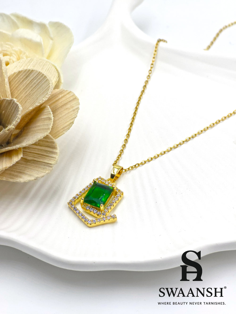 Emerald Prism Pendant by Swaansh featuring emerald-cut green crystal set in a diamond-shaped pavé frame with gold chain