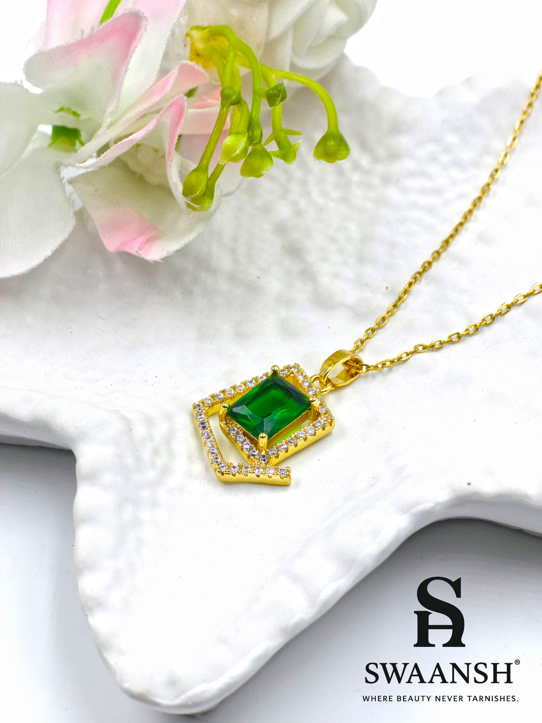 Emerald Prism Pendant by Swaansh featuring emerald-cut green crystal set in a diamond-shaped pavé frame with gold chain