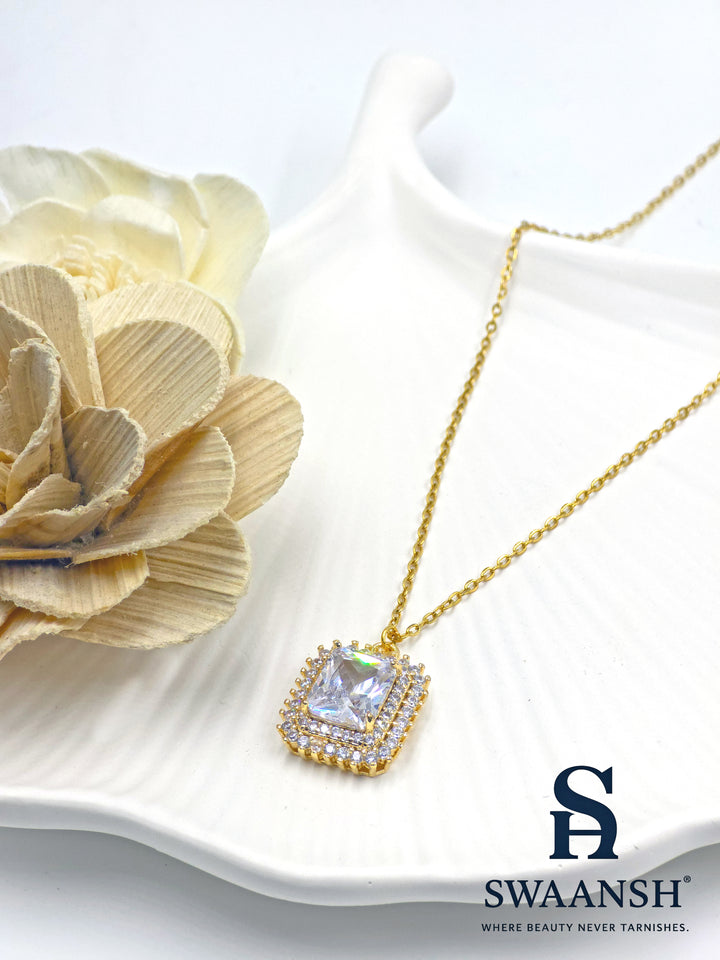 Crown Radiant Pendant by Swaansh featuring princess-cut center stone with double pavé crystal halo in square gold frame