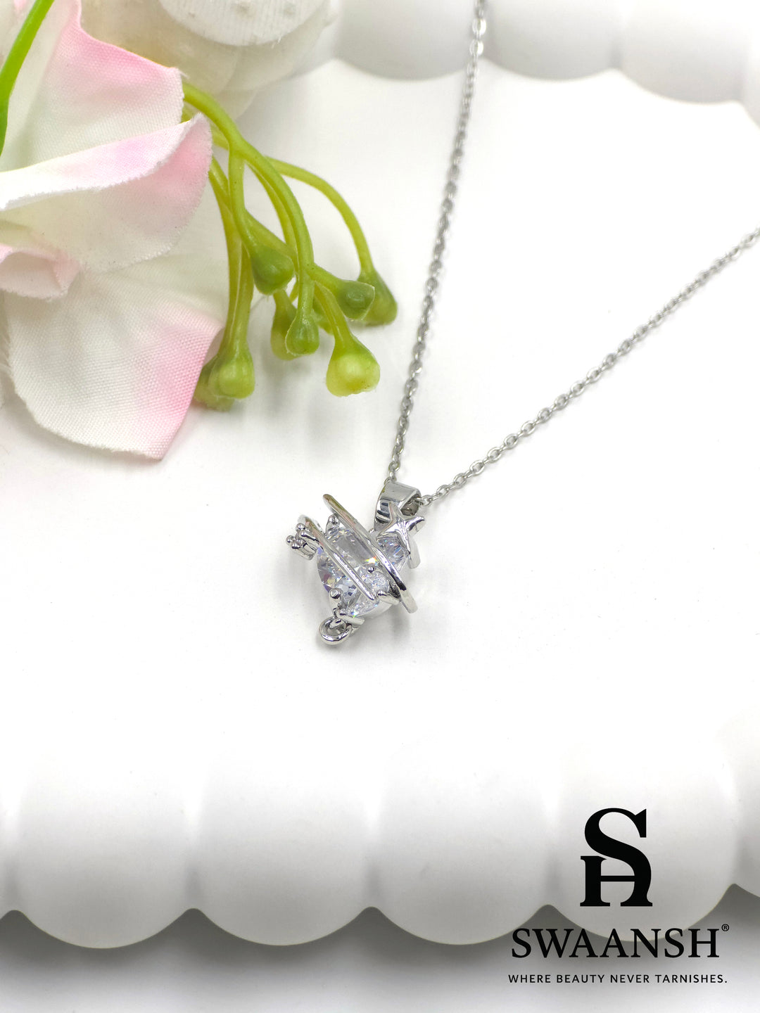 Galactic Spark Pendant by Swaansh featuring silver UFO-shaped design with central crystal accent