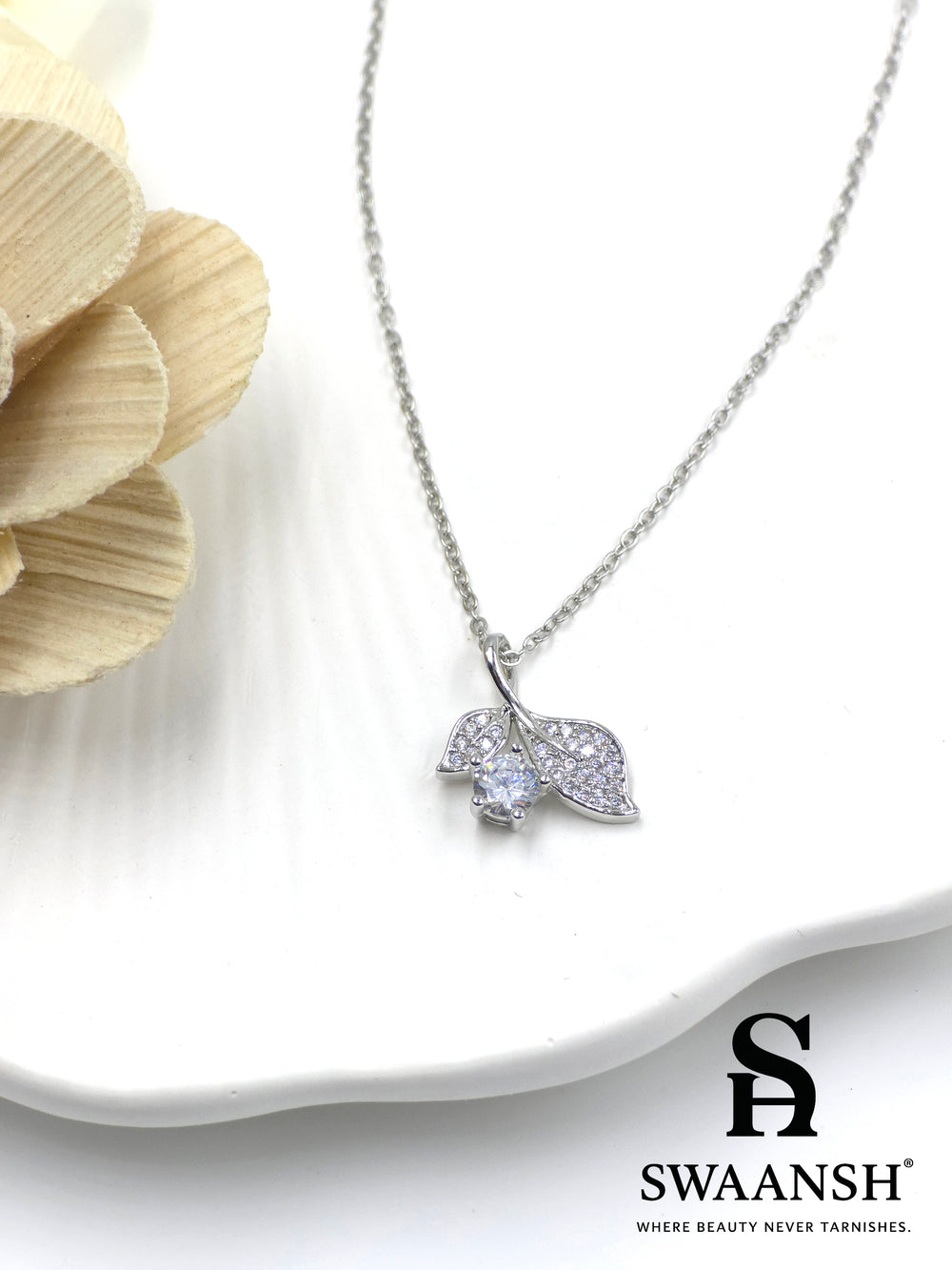 Whisperleaf Pendant by Swaansh featuring silver leaf design with pavé crystals and solitaire round accent