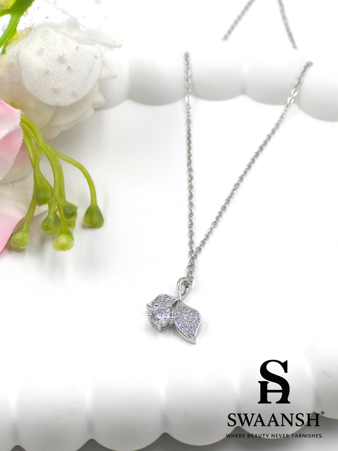 Whisperleaf Pendant by Swaansh featuring silver leaf design with pavé crystals and solitaire round accent