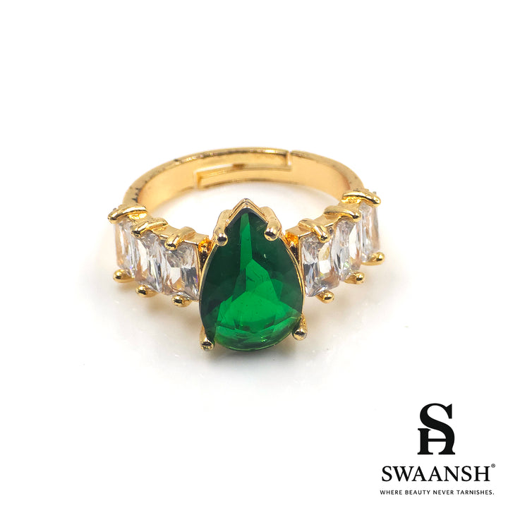 Gold ring with teardrop-shaped green stone and clear side zircons – The Emerald Royal Ring by Swaansh