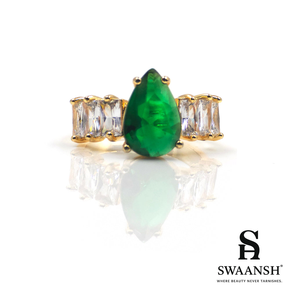 Gold ring with teardrop-shaped green stone and clear side zircons – The Emerald Royal Ring by Swaansh