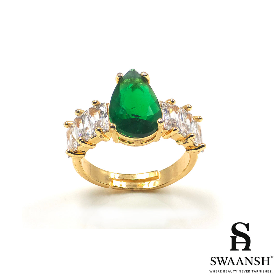 Gold ring with teardrop-shaped green stone and clear side zircons – The Emerald Royal Ring by Swaansh